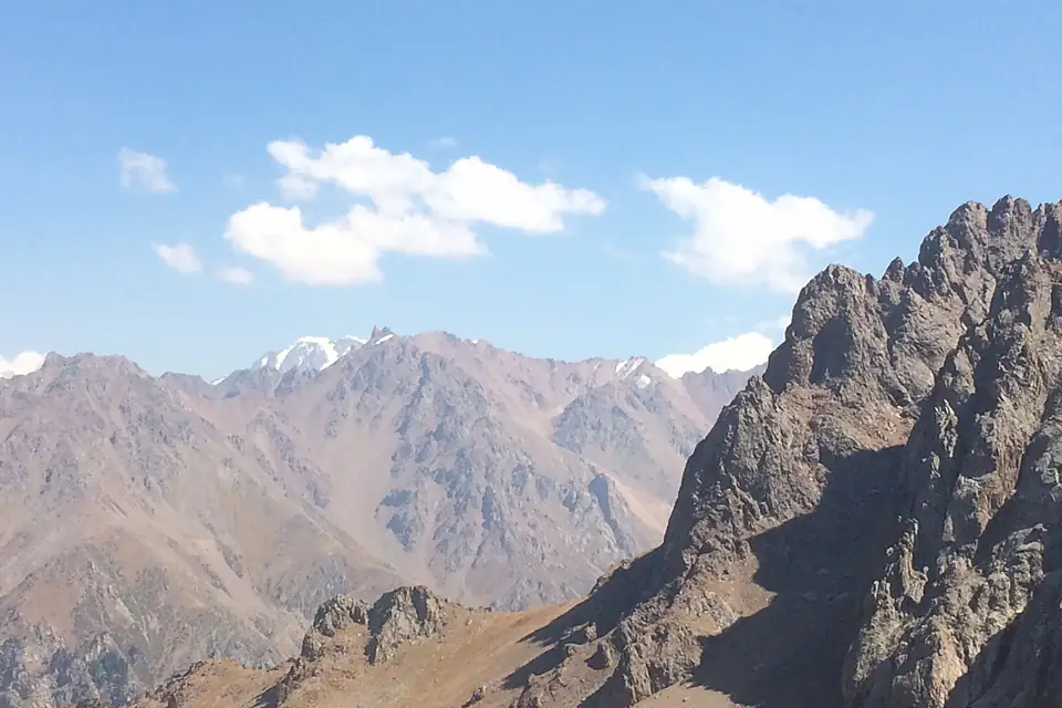 View of the snow peak Talgar (4979 m) from the Talgar Pass (3200 m) in summer